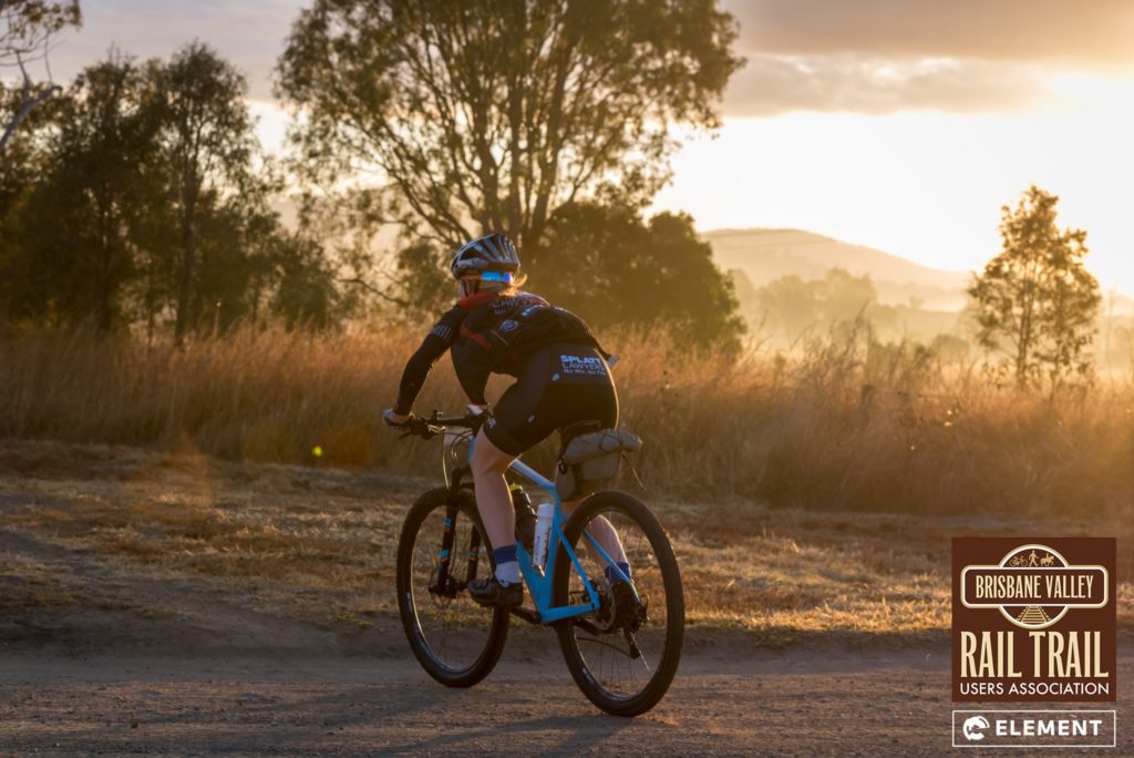 A rider goes enjoys the sunrise on the Brisbane Valley Rail Trail