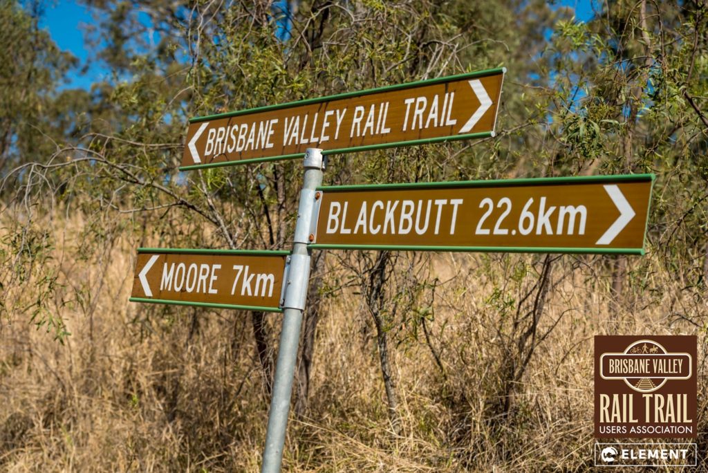 A sign makes the distance of the Brisbane Valley Rail Trail